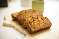 three pieces of bread sitting on top of a cutting board