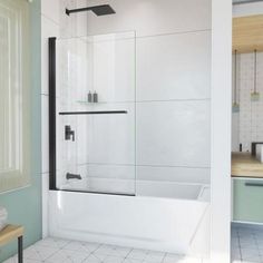 a bathroom with white tile flooring and a glass shower door in the middle of the bathtub