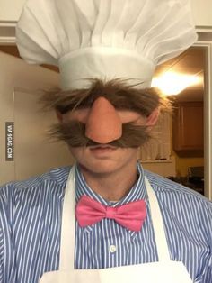 a man with a fake mustache and bow tie wearing a chef's hat on top of his head