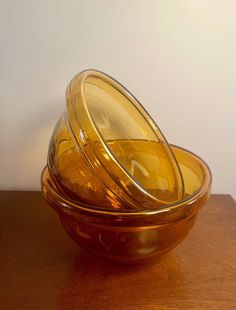 three yellow glass bowls stacked on top of each other