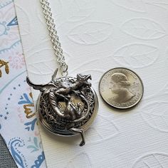 Gargoyle Dragon Guardian Protection Locket ☻Locket ~ Round Silver ~ With Bronze Bunny ~ With Flower ~ See Photos for size comparison against American quarter Chain: ~ Silver Plated YOU CHOOSE YOUR CHAIN LENGTH during checkout ☻More Lockets Here: https://www.etsy.com/shop/FashionCrashJewelry/search?search_query=lockets&order=date_desc&view_type=gallery&ref=shop_search ☻Link to The ENTIRE SHOP: https://www.etsy.com/shop/FashionCrashJewelry?ref=shopsection_shophome_leftnav&ga_search Antique Finish Pewter Jewelry As Gift, Adjustable Antique Silver Jewelry, Antique Dragon Design Jewelry Gift, Antique Dragon Design Jewelry For Gift, Vintage Dragon Design Jewelry For Gifts, Vintage Dragon Design Jewelry Gift, Vintage Jewelry With Dragon Design Gift, Vintage Jewelry With Dragon Design For Gift, Antique Silver Adjustable Locket Jewelry