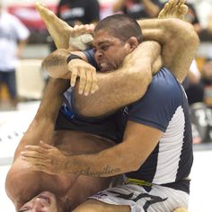 two men are wrestling in a competition