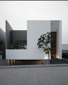 a white building with two trees in front of it