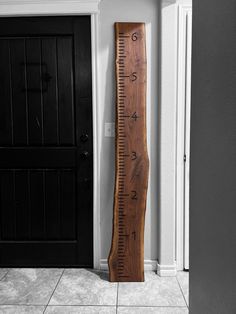 a wooden ruler leaning against the wall next to a door