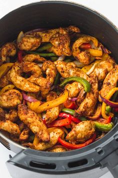 the chicken and peppers are being cooked in the slow cooker for an easy dinner