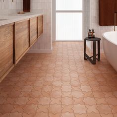 a bathroom with a tub, sink and toilet in it's center area that has brown tile on the floor