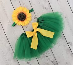 Green sunflower tutu for baby, toddler and girls. The tutu is green with a yellow bow. The matching big sunflower headband is green. Available as a headband or hair clip. Skirt Lengths: Preemie - 6/7 inches Newborn - 3M 6/7 inches 3M to 9M - 6/7 inches 12M to 24M - 7/8 inches 2T - 3T - 9/10 inches 4T- 5T -10/11 inches Custom sizing is available Find my shop here: https://www.etsy.com/shop/APocketfulofBows Sunflower Tutu, Tutu For Baby, Toddler Formal Dresses, Big Sunflower, Skirt Lengths, Green Sunflower, Sunflower Headband, Sunflower Party, Sunflower Dress