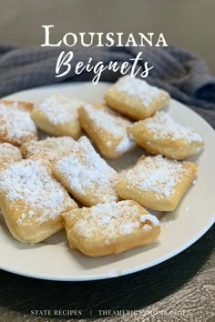 a white plate topped with powdered sugar cookies