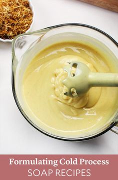 a bowl filled with liquid next to a spoon