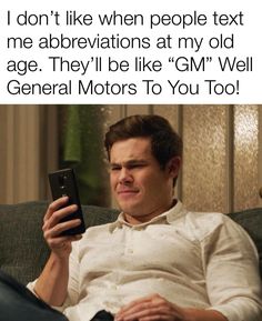 a man sitting on top of a couch holding a cell phone in his hand and texting, i don't like when people text me abbreviations at my old age they'll be like gmg general motors to you too