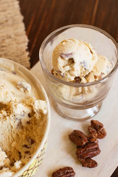 an ice cream dish with pecans next to it