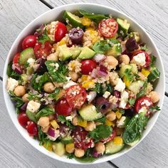 a salad with cucumbers, tomatoes, chickpeas and feta cheese