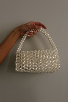 DETAILS: Our Pearl Bead All Over Handle Bag In White is a stunning bag with a pearl strap handle and non-lined pearl bag. DIMENSIONS: 8.25X4X4.25 Pearl Sling Bag, White Beaded Bag, Pearl Bag Pattern, Beads Bags Handmade, Pearl Choker Wedding, Pearls Bag, What To Sew, Bunny Sewing Pattern, Pearl Bags