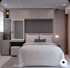 a bedroom with a bed, nightstands and a mirror on the wall above it