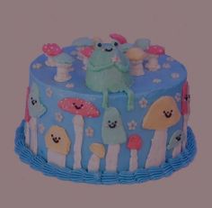 a blue cake decorated with cartoon characters on it