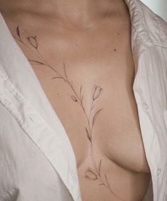 an instagram photo of a woman's chest with flowers on it