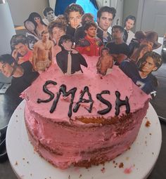 a birthday cake with the name smash on it and pictures of people behind it,