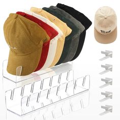 five hats are on display in front of a rack with hooks for earplugs