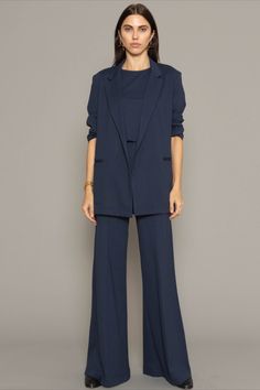 Fall Lapel Collar Pantsuit For Work, Fall Workwear Pantsuit With Lapel Collar, Classic Structured Fall Pantsuit, Fall Business Casual Pantsuit With Lapel Collar, Business Casual Pantsuit With Lapel Collar For Fall, Chic Lapel Collar Pantsuit For Workwear, Chic Pantsuit With Pressed Crease And Lapel Collar, Chic Fall Pantsuit With Hidden Button Closure, Fall Pantsuit With Pressed Crease