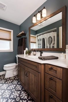 a bathroom with blue walls and white fixtures