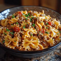 a close up of a bowl of food with noodles and meat on the side,