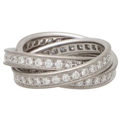 A classic Cartier diamond trinity ring set in 18k white gold. The ring is composed of three interlinked 3.5-millimetre bands that are designed to roll with ease on the finger. All of the bands are completely set with round brilliant cut diamonds which has a beautiful effect once on the finger. Because of the design this ring could be worn for a variety of occasions. There is a total diamond weight of 1.60 carats. These diamonds are estimated to be F-G in colour with VS clarity. This particular t Cartier Diamond, Tiffany And Co Jewelry, Trinity Ring, Edwardian Jewelry, Bespoke Engagement Ring, Gold For Sale, Eternity Ring Diamond, Emerald Earrings, Dress Rings