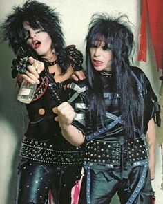 two women dressed in punk clothing posing for the camera