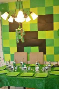 an image of a table setting with green and brown decorations on it for a party