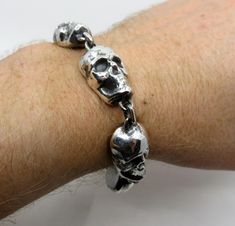 Very heavy, solid sterling silver skull bracelet. Oxidised details on the individual skulls give the piece a stunning vintage rock and roll finish. Beautiful skull details on the T bar catch. Dimensions of skull bracelet: Skull dimensions 16mm x 23mm x 10mm Weight 155.5 grams (10" length) Smaller lengths work better with  a trigger catch, get in contact to finalize the design and see options if required. I make different lengths, this particular one is a 10" length. My wrist in the pics is 7.25" Hand Cuff Bracelet, Steer Skull, Gothic Bracelet, Silver Chain Style, Skull Bracelet, Keith Richards, Vintage Rock, Skull Ring, Skull Design