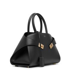 Black leather top-handle bag from Ferragamo. The Hug top-handle bag is made of supple leather with gold-toned "Gancini" buckles along with studs at the base.Measurements: L32.5 x H22 x W16cmMade in Italy Designer Double Handle Bags With Gold-tone Hardware, Designer Satchel With Gold-tone Hardware For Daily Use, High-end Satchel With Gold-tone Hardware For Shopping, High-end Shopping Satchel With Gold-tone Hardware, Designer Satchel Shoulder Bag With Gold-tone Hardware, Designer Satchel With Gold-tone Hardware, High-end Satchel Tote With Branded Hardware, Designer Satchel With Branded Hardware, Timeless Top Handle Bag With Metal Hardware