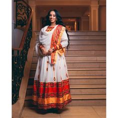 This exquisite Ethiopian Habesha dress is a true masterpiece of traditional craftsmanship. The lower part of the dress is made of Shimena, which is handwoven with great care and attention to detail, resulting in a beautiful and unique texture. The Menen fabric used in this dress is of the highest quality, adding a luxurious feel to the overall design. The neckline and wrists of the dress are adorned with intricate Tilf embroidery, adding an elegant and sophisticated touch to the vibrant colors o Eritrean Dress, Habesha Dress, Habesha Kemis, Traditional Techniques, Dresser, The Dress, Overalls, Hand Weaving, Vibrant Colors