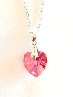 Lovely rose pink Aurora Borealis Swarovski Crystal heart on delicate sterling silver necklace. Beautiful faceted 14mm Swarovski rose pink heart with Aurora Borealis finish to give extra sparkle and depth. Simple Sterling silver bail attaches heart easily to delicate sterling silver cable chain with spring ring clasp. Also available on high quality silver plate cable chain with lobster claw clasp. Both are lovely. Slight difference in bail but both are simple design. Pink Open Heart Sterling Silver Necklace, Pink Sterling Silver Heart Cut Necklace, Pink Sterling Silver Heart Pendant Necklace, Pink Sterling Silver Heart Necklace, Pink Sterling Silver Open Heart Necklace, Pink Heart-shaped Sterling Silver Necklace, Valentine's Day Pink Sterling Silver Heart Necklace, Pink Open Heart Necklace Gift, Pink Open Heart Necklace For Valentine's Day