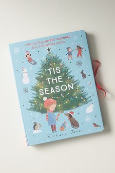 a children's book titled it's the season with a red ribbon on top