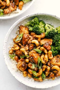 two bowls filled with chicken, broccoli and rice on top of a table