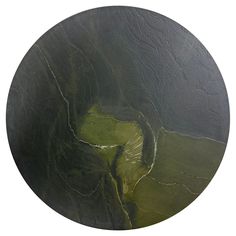 an aerial view of a river in the middle of a green field with water running through it