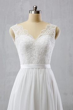 a white dress on a mannequin dummy with lace and tulle over it