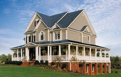 a large house sitting on top of a lush green field