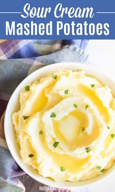 mashed potatoes with butter and parsley in a white bowl on a checkered cloth