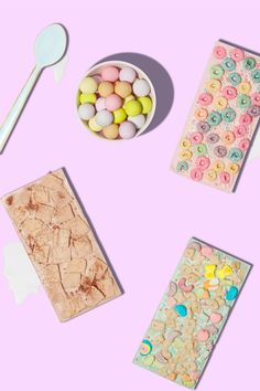 three different types of cookies, spoons and candy on a pink background with pastel colors