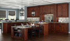 a large kitchen with wooden cabinets and marble counter tops