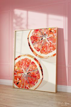 two orange slices are displayed in front of a pink wall