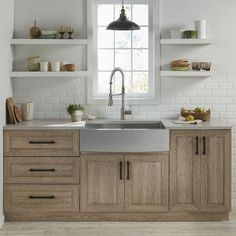 a kitchen with wooden cabinets and white tile backsplash, open shelving above the sink