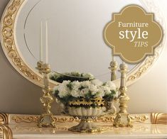 an ornate mirror with candles and flowers on it in front of a fireplace mantel