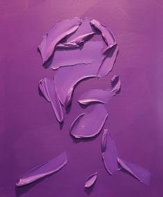 purple paint is being applied to the face of a woman's head on a purple background