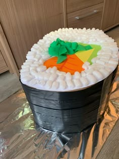 a cake made to look like a bucket with carrots on it