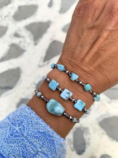 These stunning bracelets feature genuine sky blue Barahona Larimar nuggets, renowned for their captivating blue hues reminiscent of the tropical color of Caribbean sea!  ▽▲Details▽▲ ⭐AAAA sky blue Larimar nuggets 16-17mm ⭐AAAA Cube rectangle nuggets 7mm ⭐AAAA Freeform nuggets 5mm ⭐Smooth polish finish ⭐Silver mineral graphite beads (tarnish free) ⭐Clever fastening to secure perfect fit ⭐Adjustable length ⭐Allergy free/Nickel free ⭐Waterproof use ⭐Handmade excellency Larimar is a rare blue copper Aquamarine Turquoise Bracelet For Healing, Spiritual Aquamarine Turquoise Bracelets, Spiritual Turquoise Aquamarine Bracelets, Turquoise Aquamarine Healing Bracelet, Turquoise Larimar Bracelet, Handmade Adjustable Larimar Bracelets, Bohemian Larimar Natural Stone Jewelry, Silver Bracelets With Amazonite And Natural Stones, Bohemian Larimar Jewelry With Natural Stones