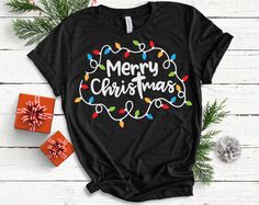 a black shirt with merry christmas lights on it