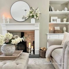 a living room filled with furniture and a fire place in front of a white fireplace