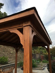 a wooden gazebo sitting on top of a patio