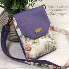 a purple purse sitting next to a potted plant